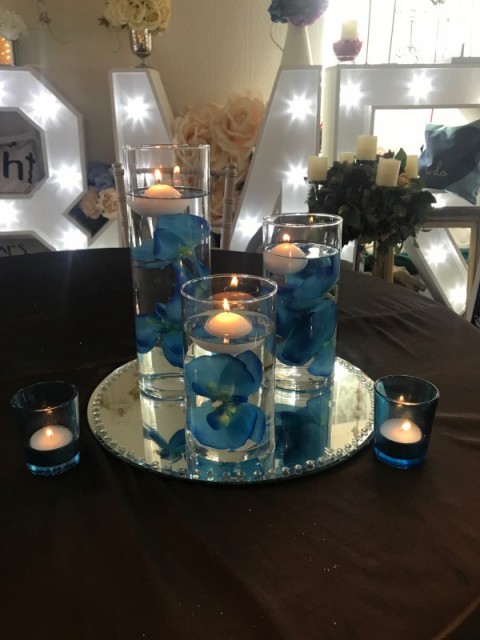 Three glass tubes. Small, medium and large with floating candles