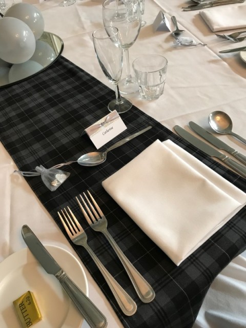 Grey Granite tartan runner. £5 each to hire, replacement value £20.00